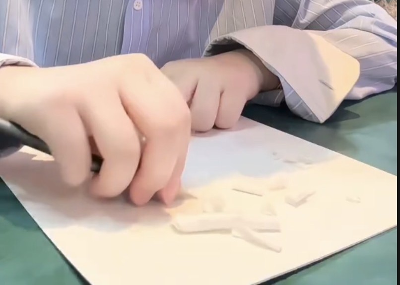 Hands carving a portrait by hand